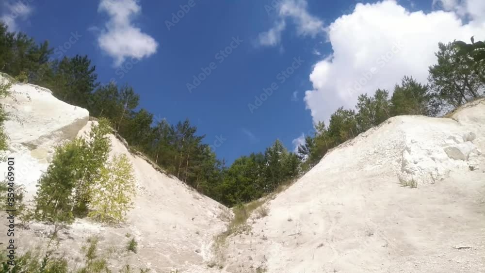 white clouds fly over the chalky slopes overgrown with spruce white clouds fly over the chalky slopes overgrown with spruce