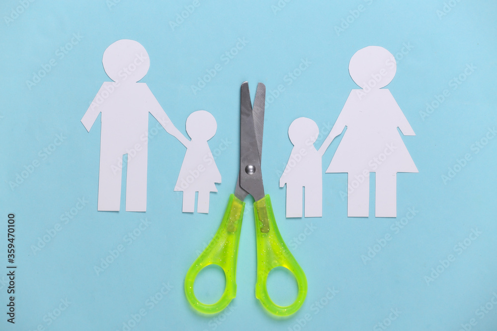 Broken family, divorce. Scissor-cut paper family on blue background Broken family, divorce. Scissor-cut paper family on blue background