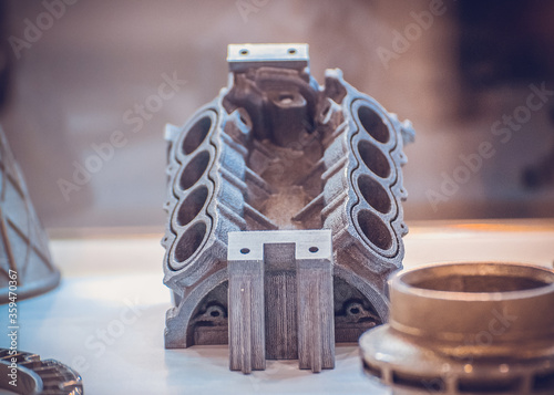 Man is holding object printed on metal 3d printer. photo