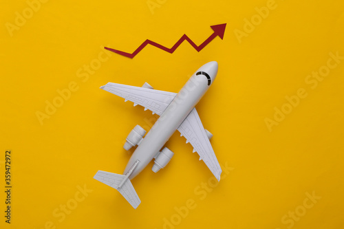 Airplane with growth arrow on a yellow background. Top view