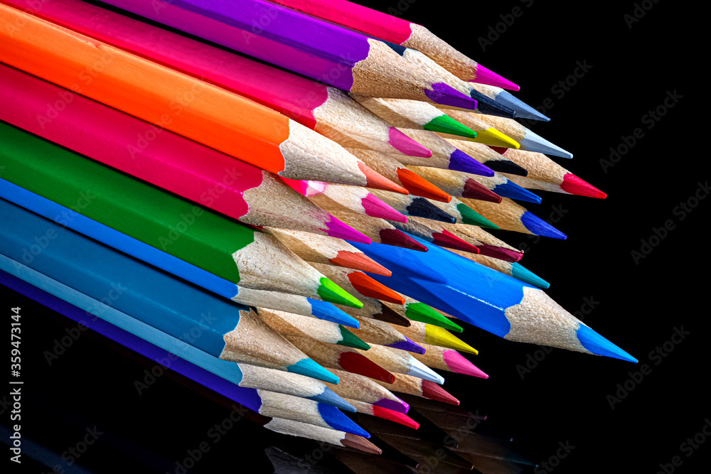 Bunch of colored pencils lying on black background Bunch of colored pencils lying on black background