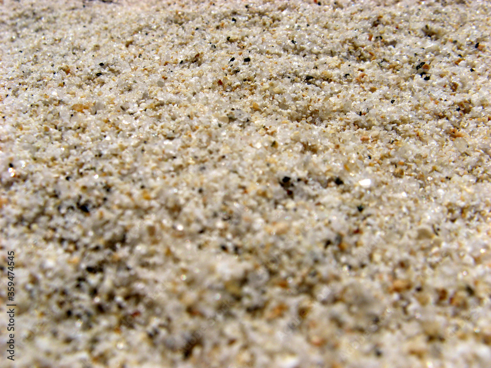 Beach sand texture background. Macro and bokeh effects. Creative wallpaper. 