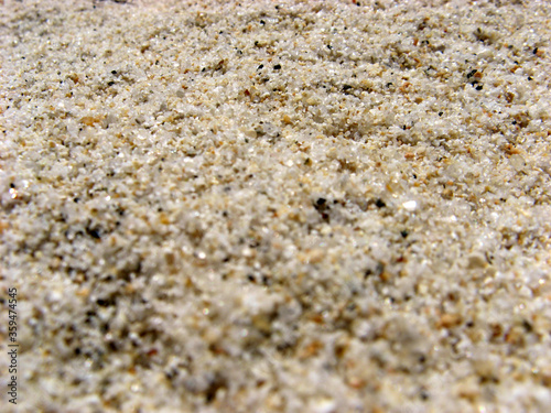 Beach sand texture background. Macro and bokeh effects. Creative wallpaper. 