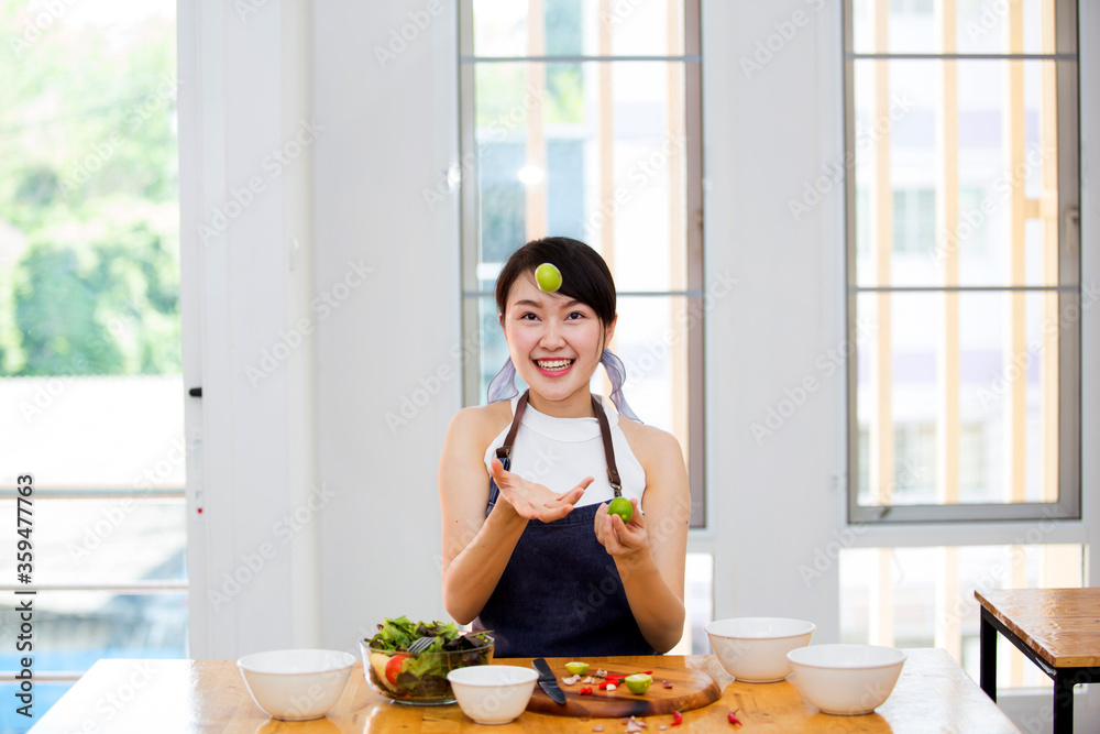 Beautiful Asian women, beautiful smile, good health, beautiful teeth, eating salad vegetable when working at home. Beautiful Asian women, beautiful smile, good health, beautiful teeth, eating salad vegetable when working at home.