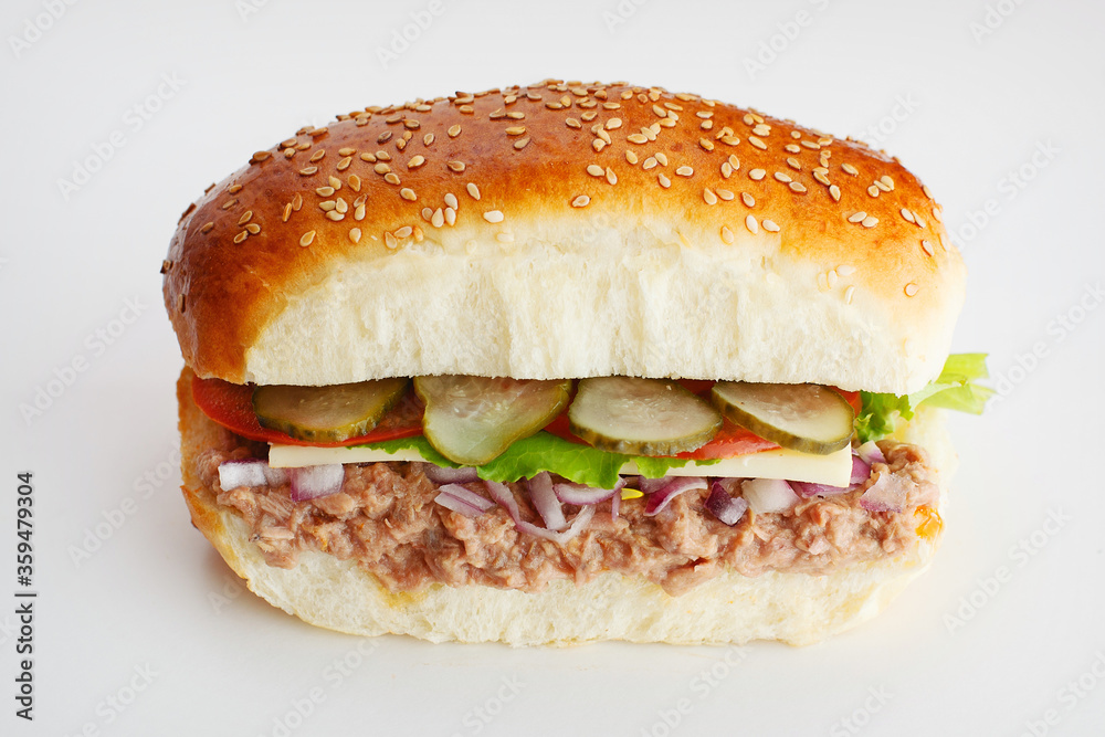 Juicy sandwich with cucumbers, lettuce, cheese, onion and tuna on a white background Juicy sandwich with cucumbers, lettuce, cheese, onion and tuna on a white background