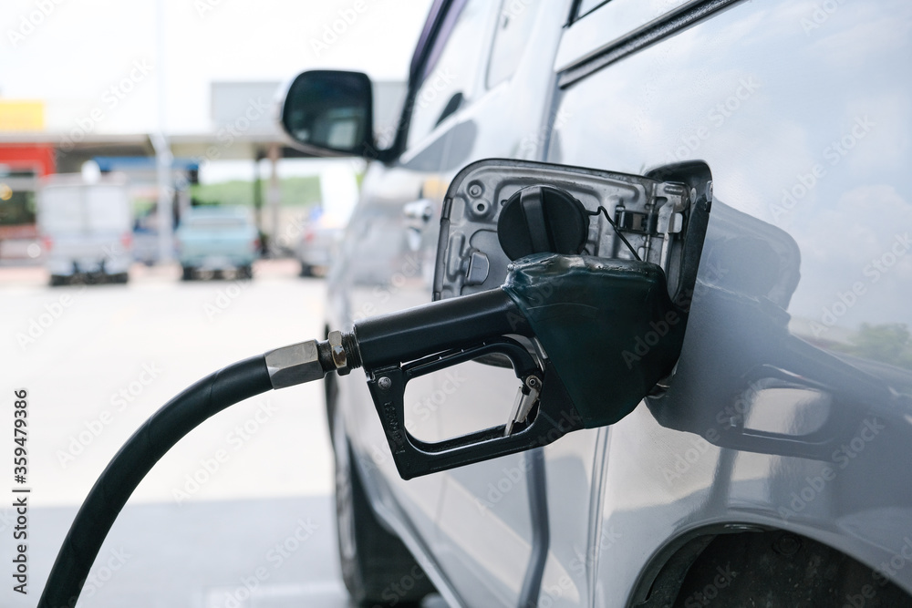 Car refueling fuel on petrol station. Man pumping gasoline oil. Service is filling gas or biodiesel into the tank. Automotive industry or transportation concept Car refueling fuel on petrol station. Man pumping gasoline oil. Service is filling gas or biodiesel into the tank. Automotive industry or transportation concept