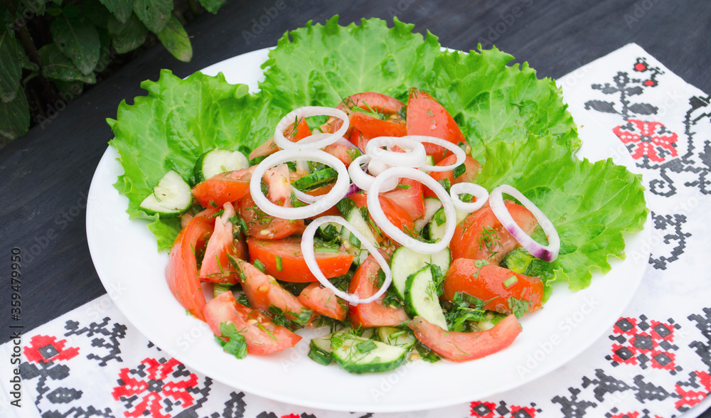 Salad with juicy tomatoes, lettuce, cucumber, red onion, arugula, dill and fresh parsley. Homemade food. The symbolic image. The concept of tasty and healthy vegetarian food. Top view and side view. Salad with juicy tomatoes, lettuce, cucumber, red onion, arugula, dill and fresh parsley. Homemade food. The symbolic image. The concept of tasty and healthy vegetarian food. Top view and side view.