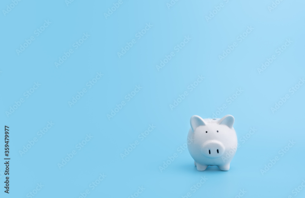 Piggy bank with copy space on blue background,front view Piggy bank with copy space on blue background,front view