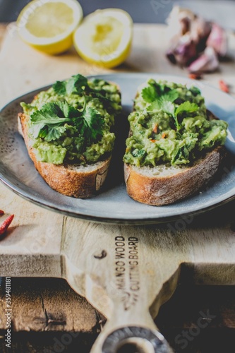 Healthy avocado toast on the wooden cutting board 