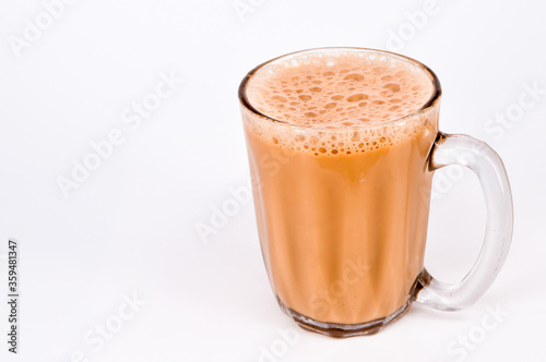Teh tarik or pulled tea is a famous sweet milk tea in Malaysia. Bubble is floating on the surface of teh tarik. photo
