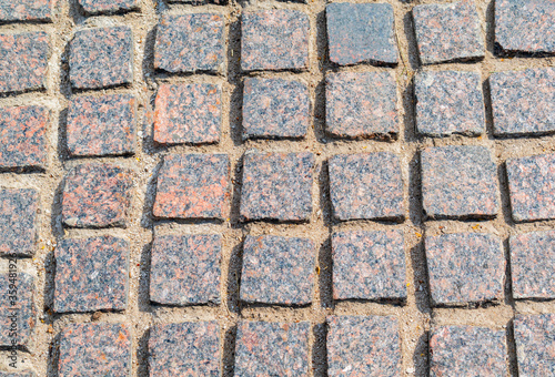 stone pavement of multicolored granite close up