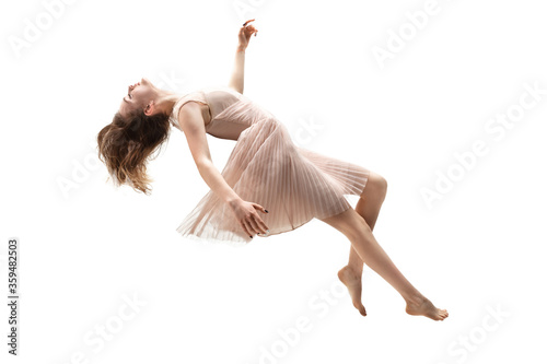 Mid-air beauty cought in moment. Full length shot of attractive young woman hovering in air and keeping eyes closed. Levitating in free falling, lack of gravity. Freedom, emotions, artwork concept. photo