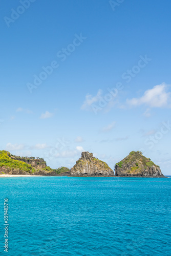 Beautiful background view of Cacimba do Padre beach with Dois Irmaos Hill and turquoise clear water, at Fernando de Noronha, Unesco World Heritage site, Pernambuco, Brazil