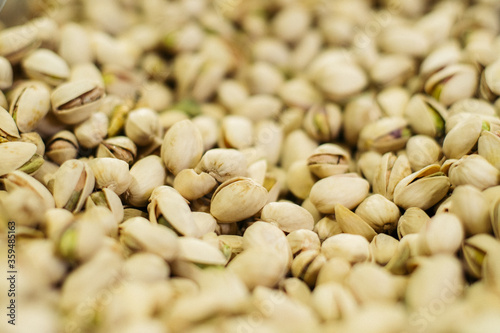Bunch of white pistachios in supermarket. Healthful uncooked nuts in grocery. Superfood, healthy eating, assortment.
