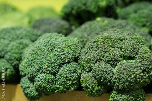 Green broccoli bunch close-up. Fresh organic vitamin vegetable in grocery or supermarket. Superfood, healthy eating, greenery, cabbage family.