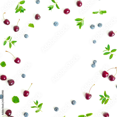 Cherry and bluebery with mint isolated on white background. Top view. Flat lay berry composition