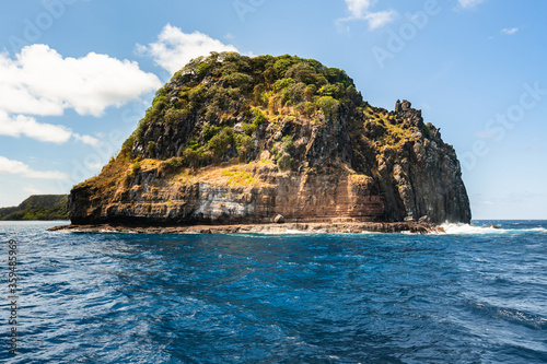 Beautiful view of the Ponta da Sapata rocks from the sea at Fernando de Noronha, a Unesco World Heritage site, Pernambuco, Brazil photo