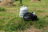 garbage bags in green meadow