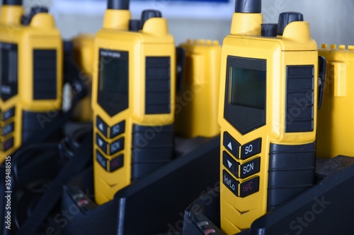 фотографія Yellow portable GMDSS VHF radio using on the ship during emergency safety or security situation, such as abandon ship or fire
