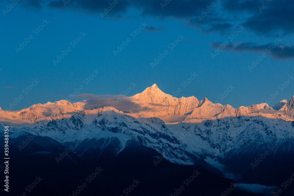 Sunrise at Snow Mountain Meili, a sacred mountain in Tibet, China.