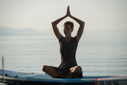 Serene young woman practicing yoga and meditation outside