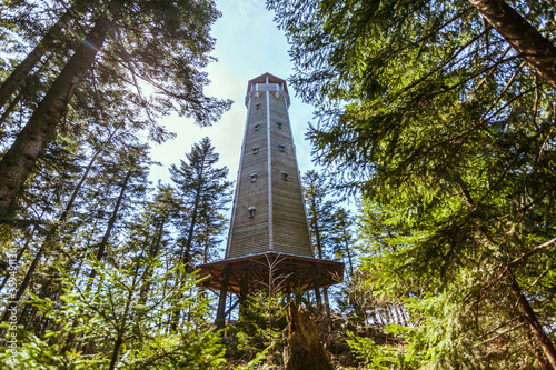 Photos beautiful wooden watchtower Na Sedle in forest with blue backround