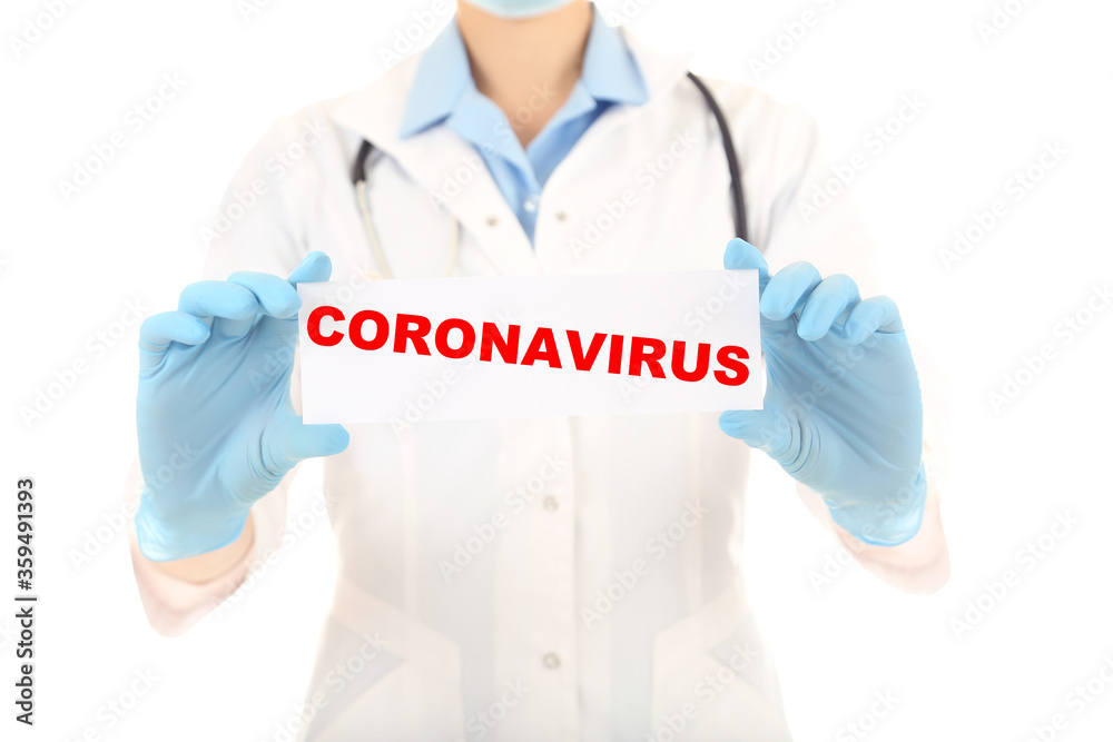 Doctor holding paper with text Coronavirus Doctor holding paper with text Coronavirus
