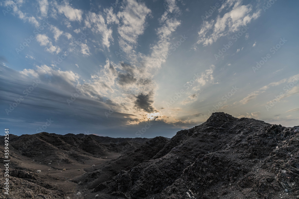 Dramatic Sunrise and Sunset in cloudy sky, Nature cloudy background with strong sunbeam and clouds, Hope concept.
