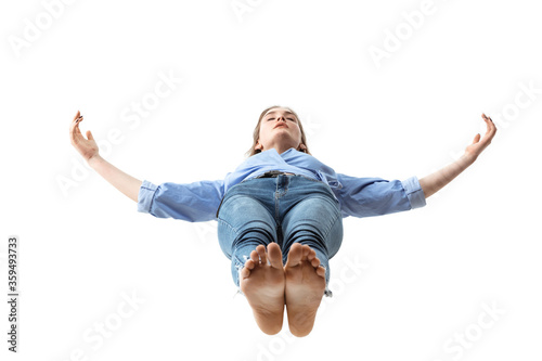 Mid-air beauty cought in moment. Full length shot of attractive young woman hovering in air and keeping eyes closed. Levitating in free falling, lack of gravity. Freedom, emotions, artwork concept.