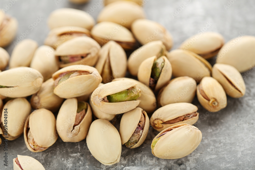 Tasty pistachios on grey background Tasty pistachios on grey background