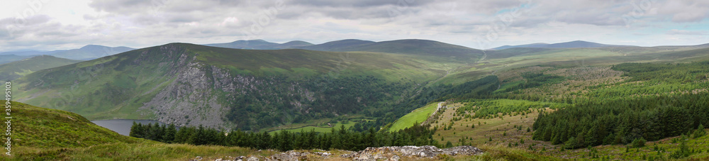 Fototapeta premium Panoramic view of Wicklow Mountains. This place is famous for uncontaminated nature, misty landscapes and lakes. Panoramic view during summer time