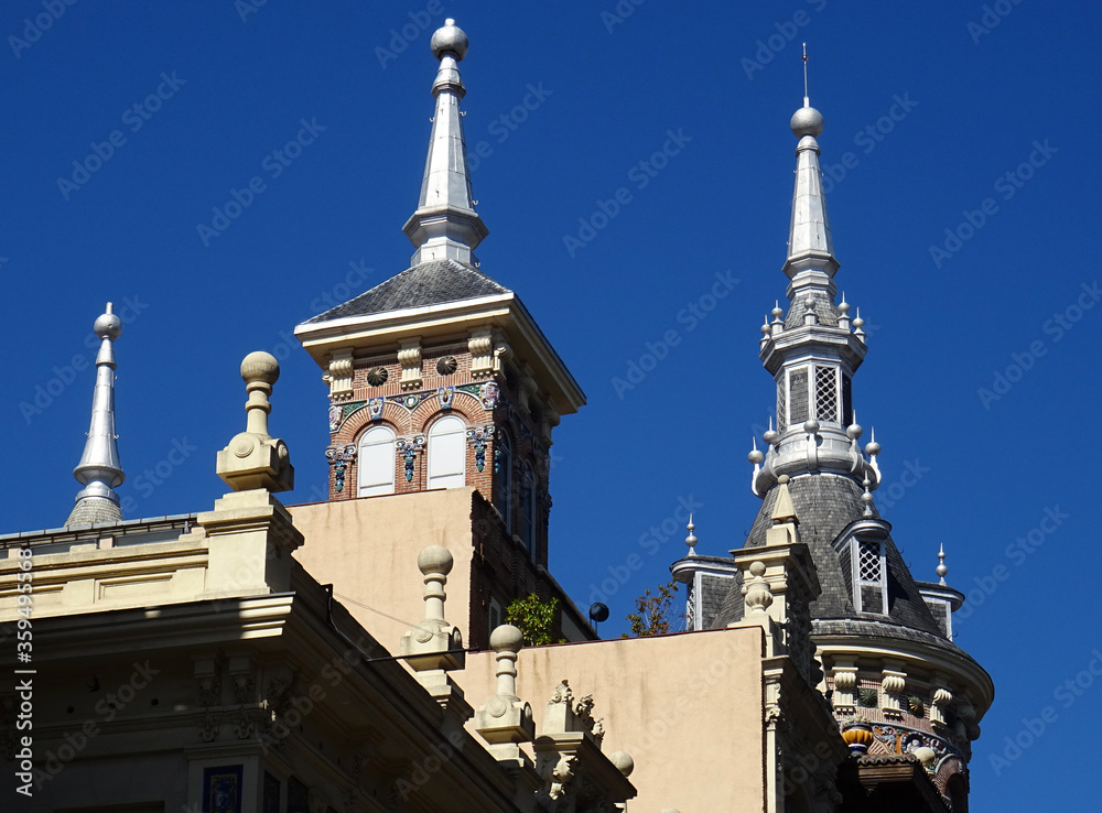 Historic colorful architecture in the old city center of Madrid. Details of the roofs and spires. Spain.  