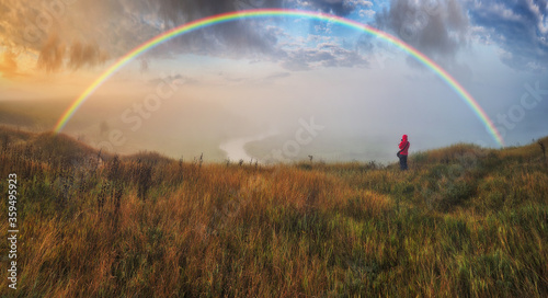 Woman Looking At Rainbow. rainbow over the autumn river