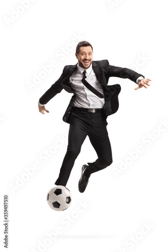 Full length portrait of a happy businessman playing football photo