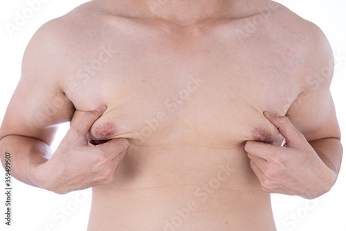 Close up man holding men boobs on white background. Diet, weight loss, slim body, healthy lifestyle concept.