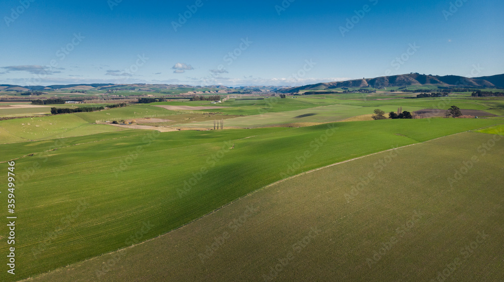 Aerial shot of  farm land with blue sky.