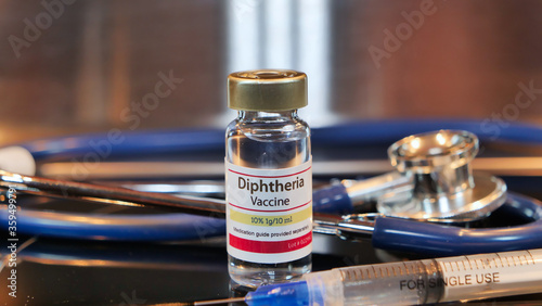 Vial of Diphtheria vaccine with stethoscope and syringe photo