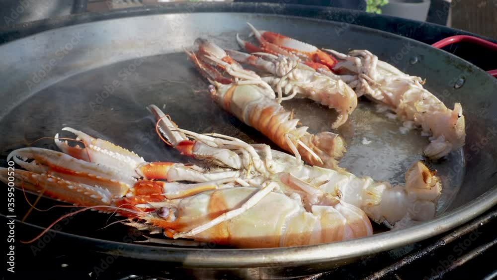 Close up video of fresh seafood cooking in paella pan Close up video of fresh seafood cooking in paella pan