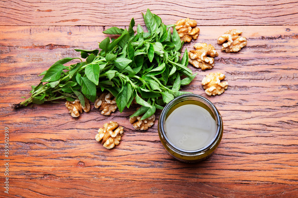 Nutrition concept - Healthy sauce of Homemade parsley pesto sauce and ingredients in glass jars over wooden background. Healthy food, Diet, Detox, Clean Eating or Vegetarian concept Nutrition concept - Healthy sauce of Homemade parsley pesto sauce and ingredients in glass jars over wooden background. Healthy food, Diet, Detox, Clean Eating or Vegetarian concept