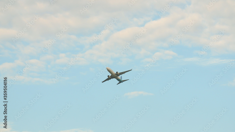 Passenger airplane takes off against the blue sky with clouds. Passenger airplane takes off against the blue sky with clouds.