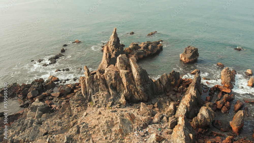 Aerial view rocks and stones on the Arambol beach in North Goa, India. Aerial view rocks and stones on the Arambol beach in North Goa, India.