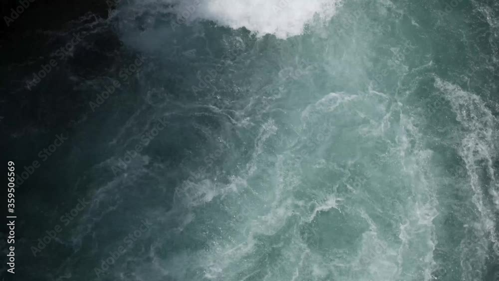 Rapid flow of blue water with foam Rapid flow of blue water with foam