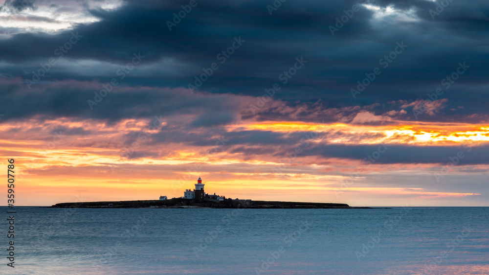 Sunrise over the sea above Coquet Island on the coast of Northumberland. England. UK>