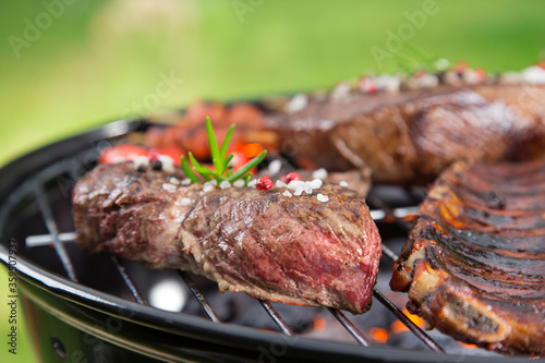 Barbecue garden grill with beef steaks, close-up.