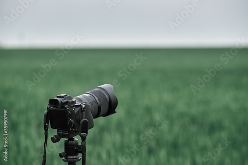 professional modern camera in the field. photo and video production