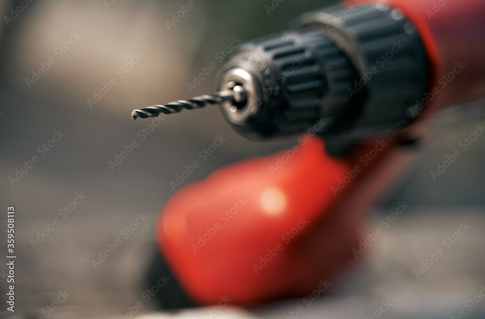 Naklejka premium top view close up of drill bit on drill instrument. professional tool. woodwork static. screwdriver outdoor on blurred background