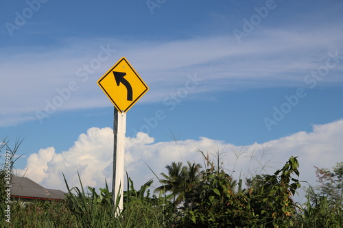 Yellow signs indicate curves on the road.