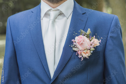 Bridegroom in blue suit with flowers in the lapel 