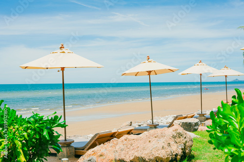 Beach loungers on deserted coast sea,Beach chairs with umbrella and beautiful beach on a sunny day