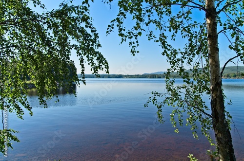 A sunny summer morning around lake Siljan with forests and rolling hills in beautiful Dalarna,Sweden photo
